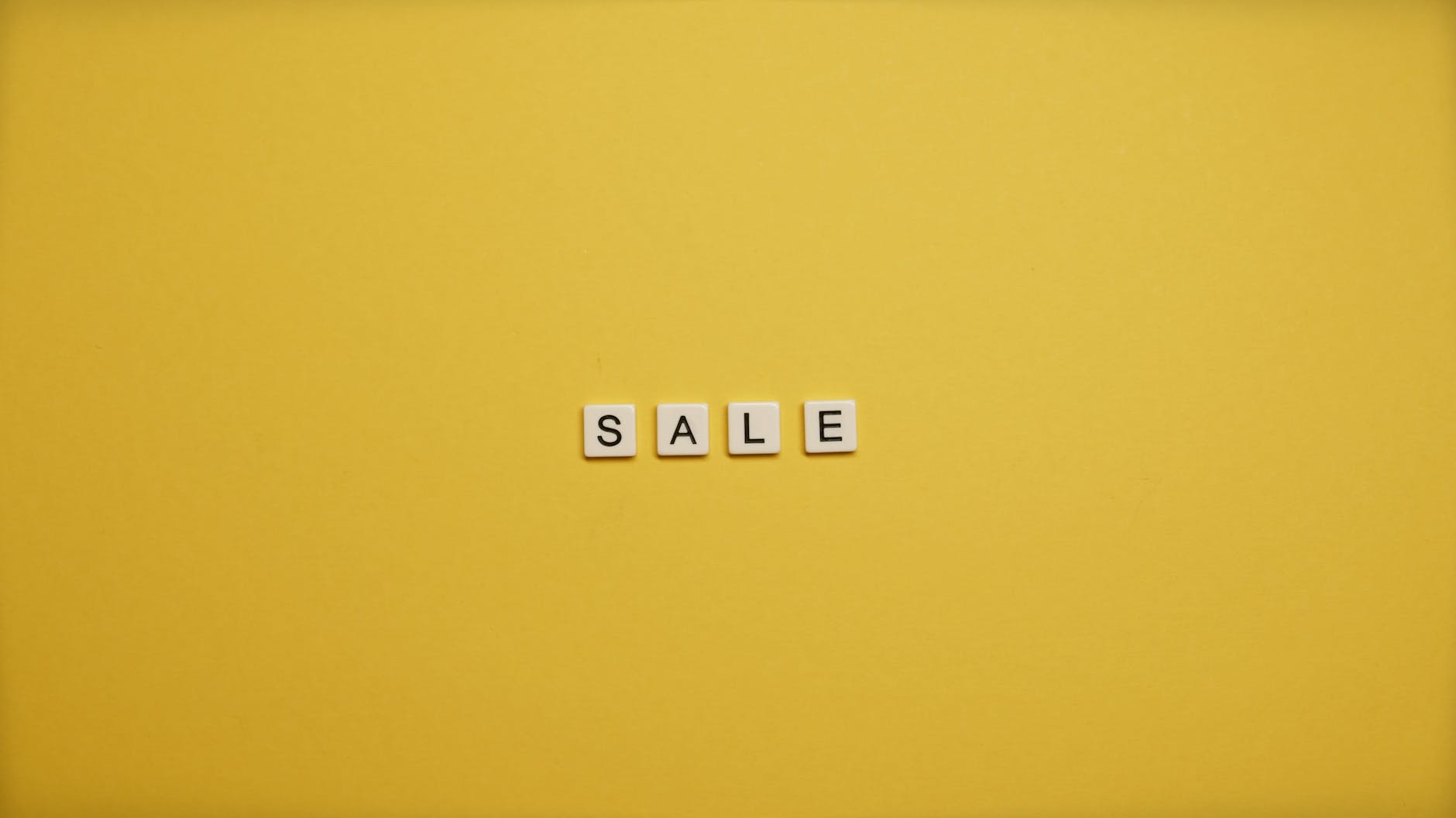 sale text on yellow background spend it all