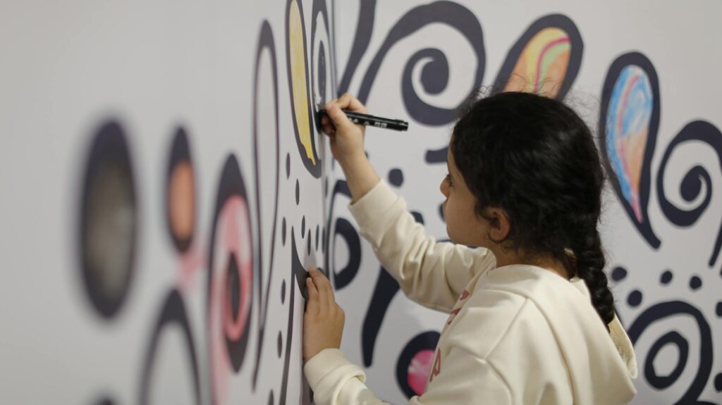 girl drawing on wall